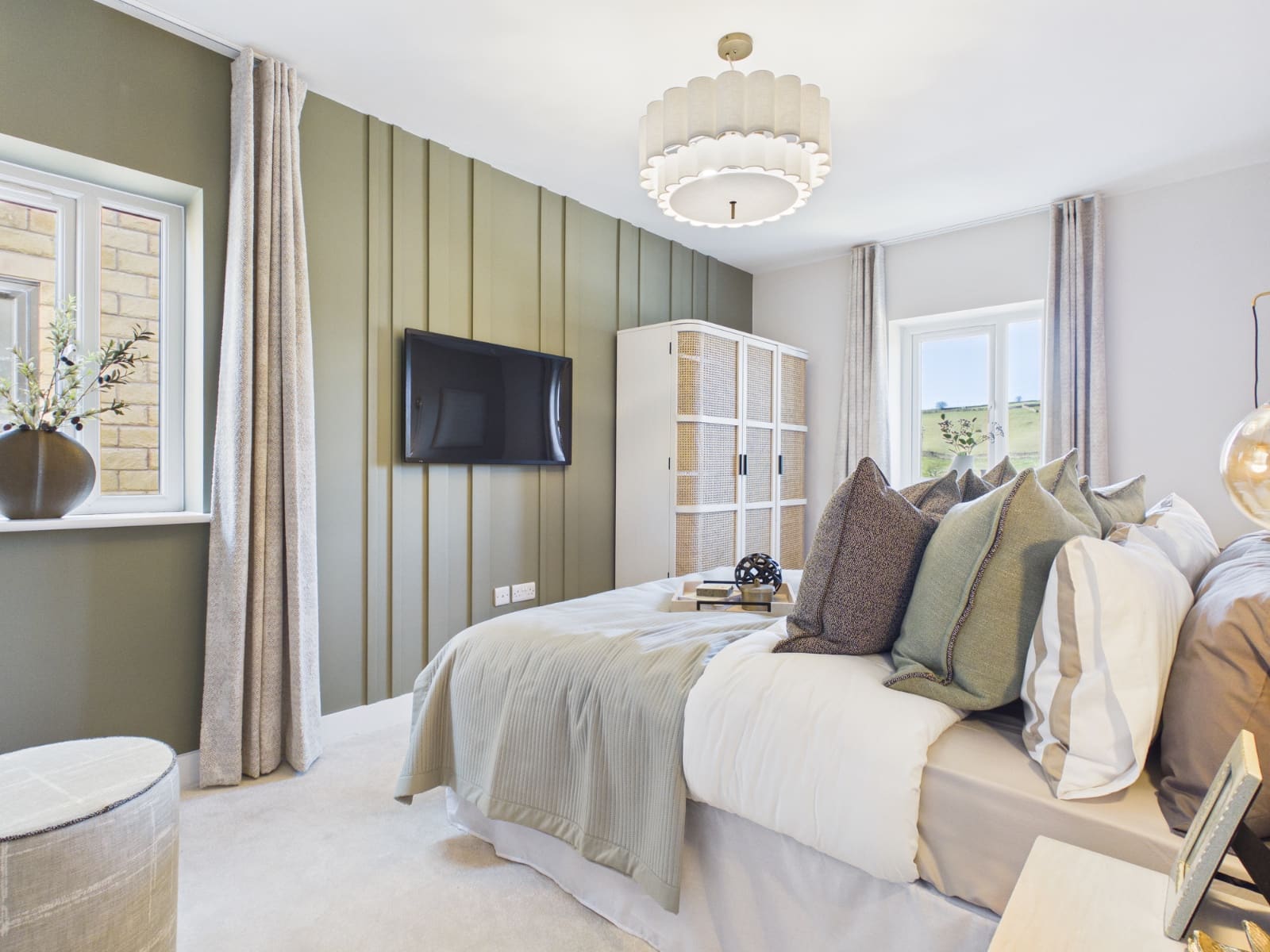 Show home bedroom with sage green panelling
